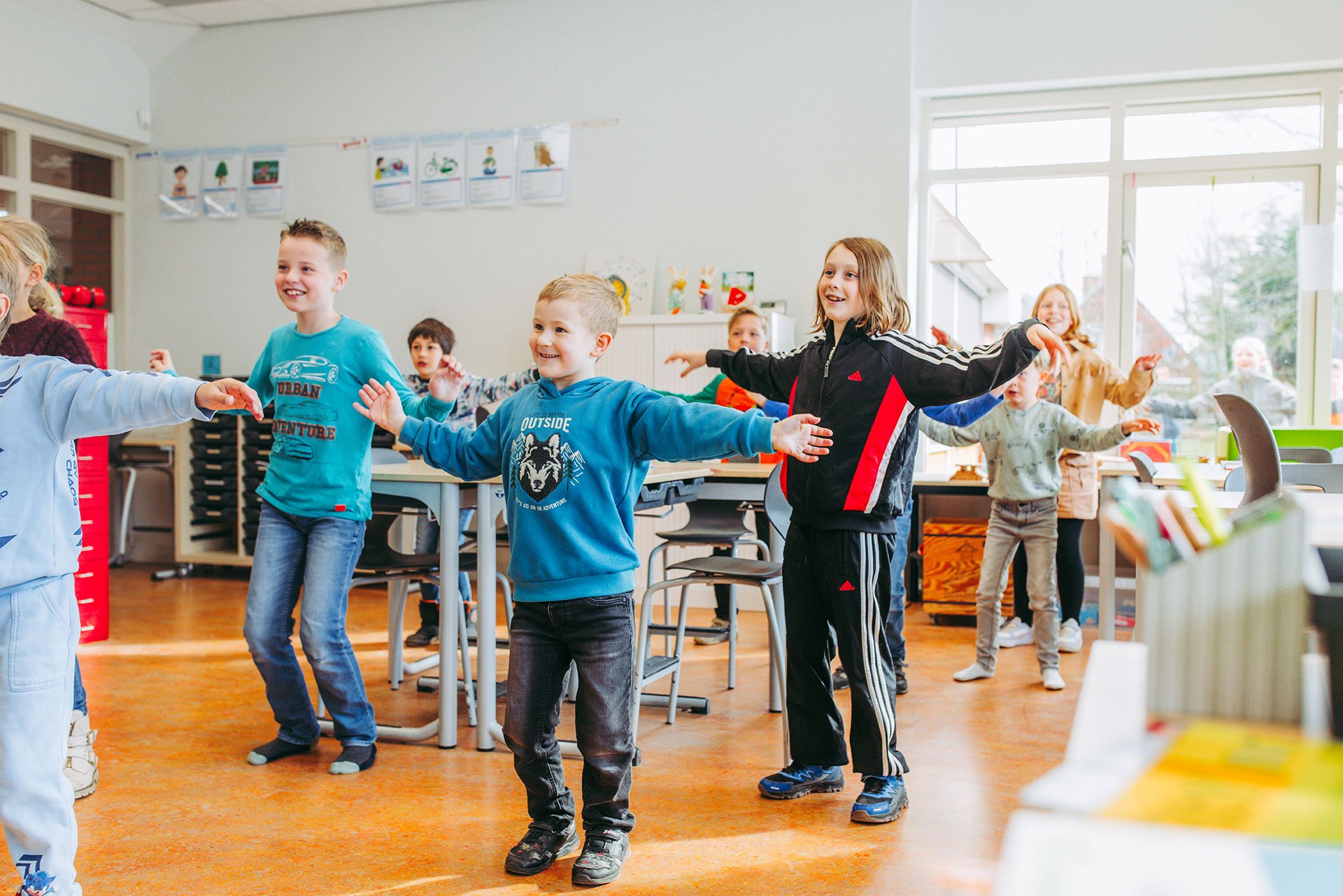kinderen zitten gezamenlijk aan tafel en werken in een werkboek